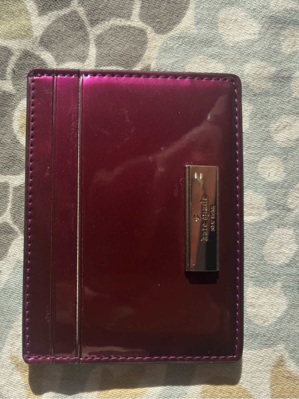 kate spade metallic plum card holder with gold-tone plaque